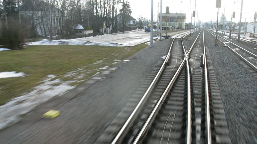 Train enters and leaves tunnel and goes by rail near with inhabited locality, time lapse