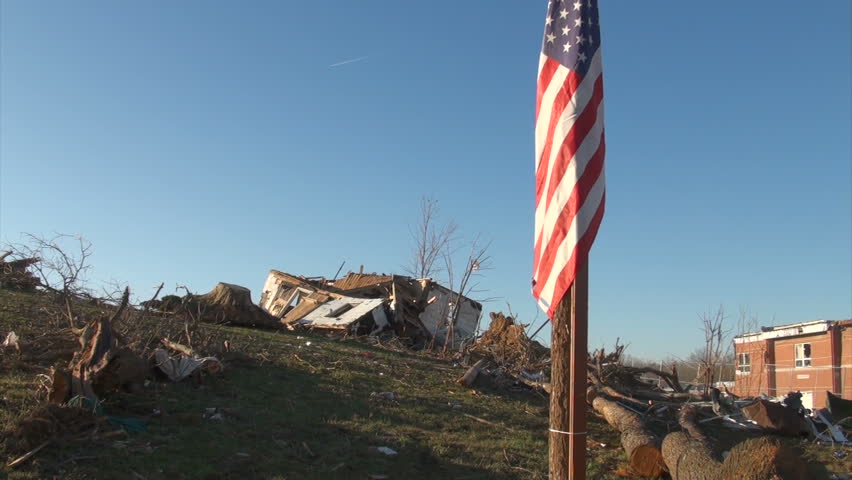 An American flag flies over the rubble in Henryville, IN, nearly a week after an EF-4 tornado struck the community on March 2, 2012. 