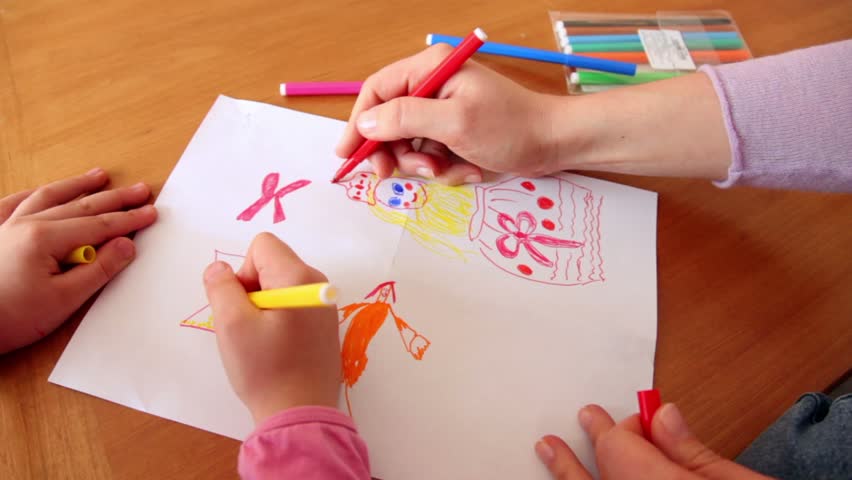 Woman and little girl draw princess on paper with colored markers, only hands are visible