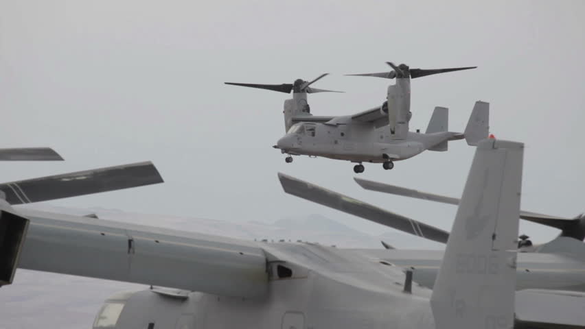 Aircraft V-22 Osprey VTOL hover mode landing on flight line while doing vertical takeoff and landing video in Utah. Used by USAF, Marines, Navy and NATO allies.