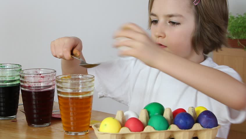 Little girl coloring Easter eggs (HD version)