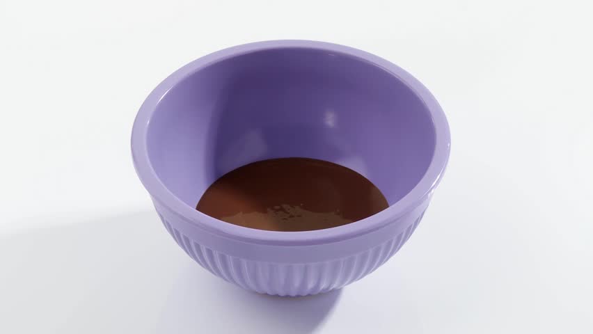 Pouring melted couverture chocolate into a dish