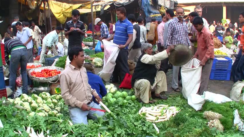 DELHI - NOV 13: Market vendors selling vegetables on a local market on November 13, 2011 in Delhi, India. India ranks second worldwide in farm output. Agriculture employs 52.1% of the total workforce.