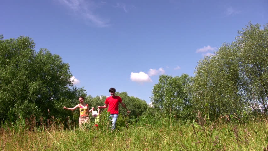 Family carry daughter in park 