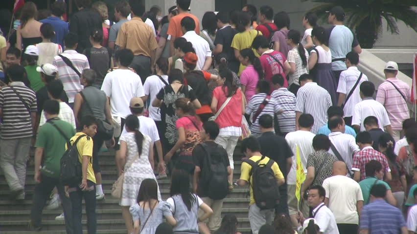 XIAN - 15 JULY 2010: Chinese tourists are walking the stairs towards the Terracotta Warrior statues in Xian