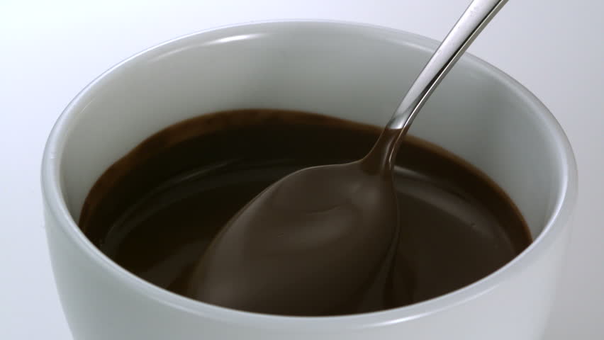 Close-up chocolate fodue being stirred with spoon