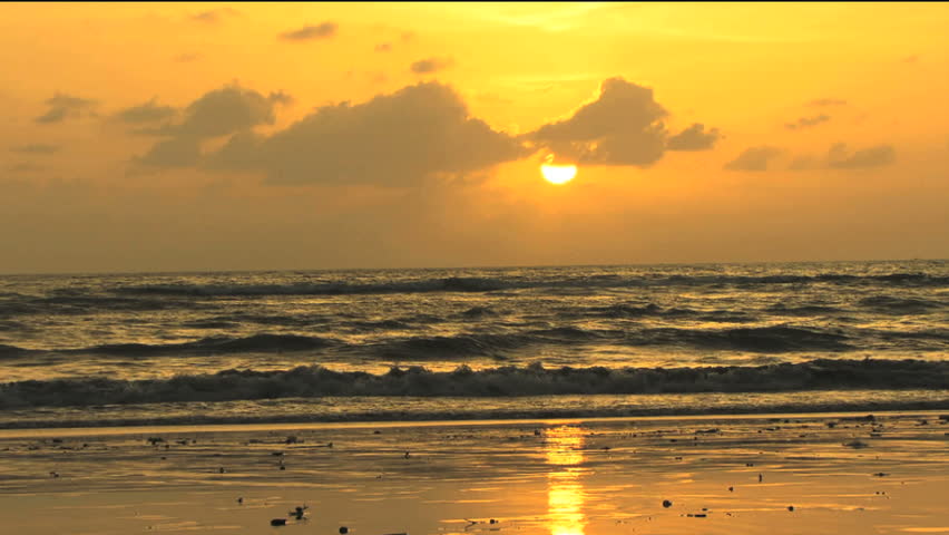 People passing by sunset and orange sky