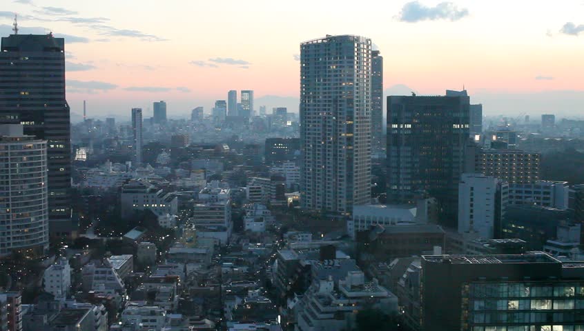 Aerial view of high-rise office buildings and residential area in downtown Tokyo, Japan during sunset