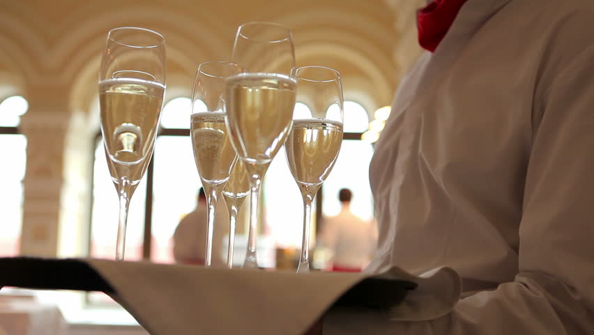 Waiter holds a tray with glasses of champagne