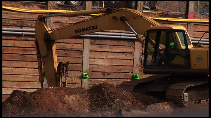 Backhoe Loader Tractor at construction site digging Medium