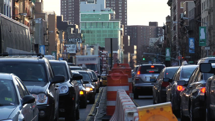 Traffic jam. Heavy congestion on the lower east side of Manhattan due to construction. Modern buildings in background. Wide Shot. 