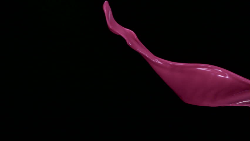 Pink liquid splash in the air on black background shooting with high speed camera, phantom flex.