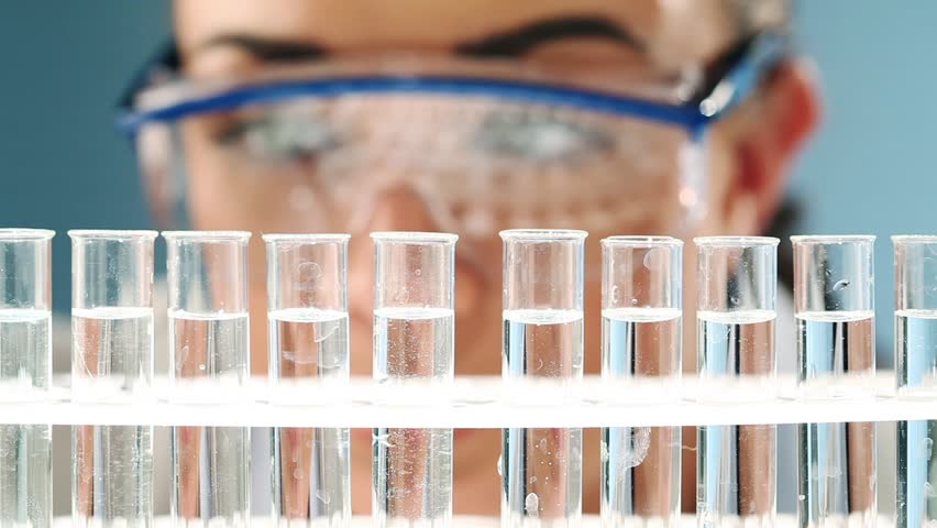 Pretty geeky science student experimenting with agriculture in laboratory