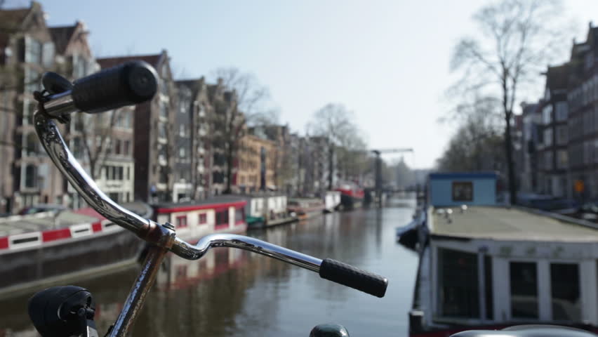 Amsterdam Canal with bicycle handlebars in foreground