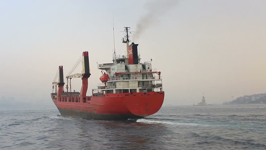 Back view of the cargo container ship. Red cargo ship
