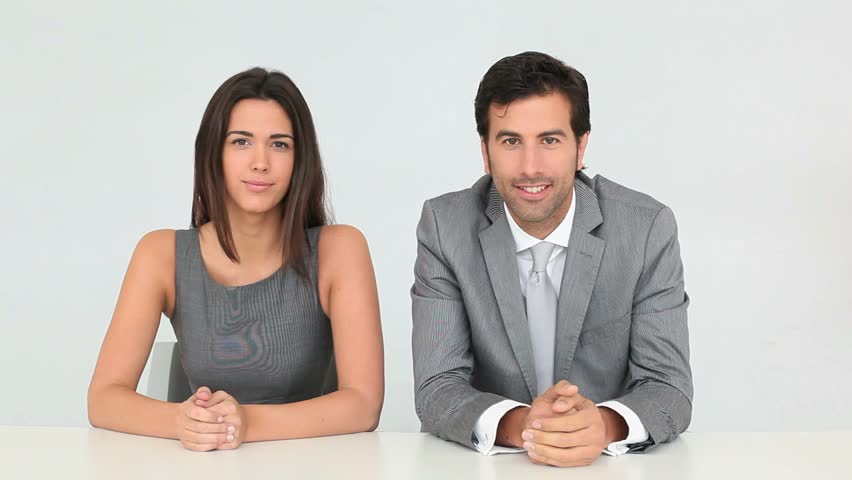 Business people talking to camera