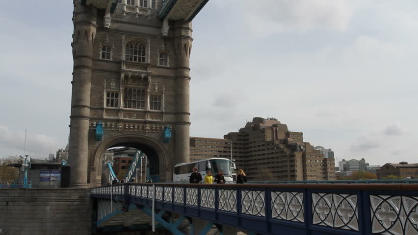 LONDON APRIL 14 2012: Pedestrians and traffic crossing Tower Bridge London April 14th 2012