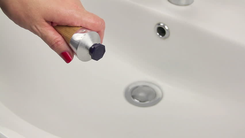 Female rubbing hands with moisturising cream.