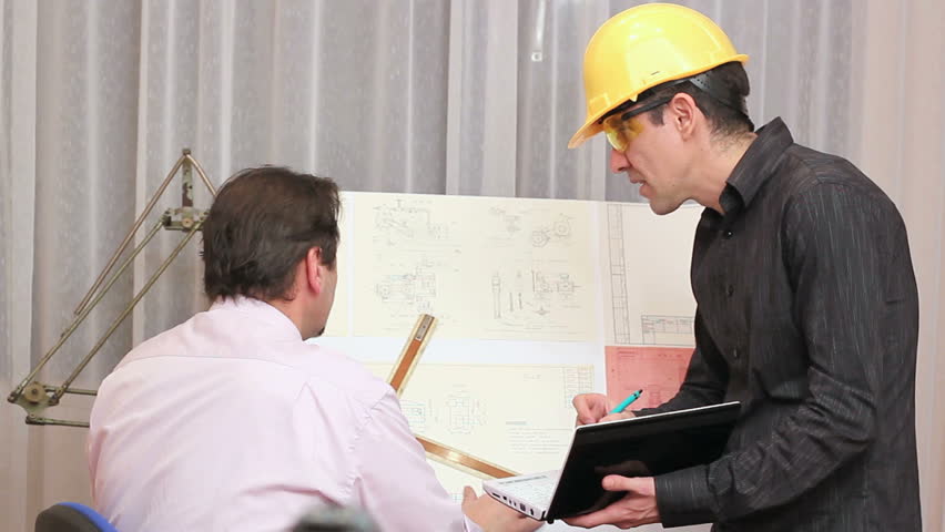 Two male engineers discussing on a blueprint. HD1080i. Tripod.