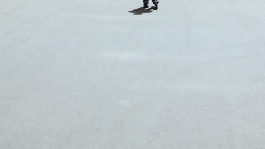 Little boy in red shirt and jeans ride on scooter by asphalt