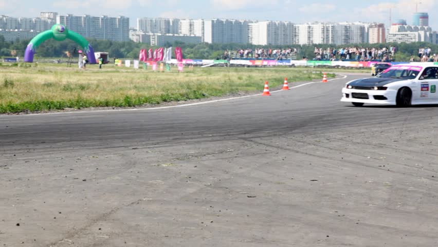 MOSCOW - JUN 11: Two cars turn on routes against city area, on 3rd stage of championship on drift Megafon-RDS 2011, on Jun 11, 2011 in Moscow, Russia