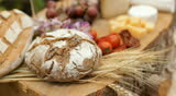 wine glass, blue cheese gouda bread grape food parmesan swiss dairy healthy france milk on table dolly shot outdoors in a vineyard 