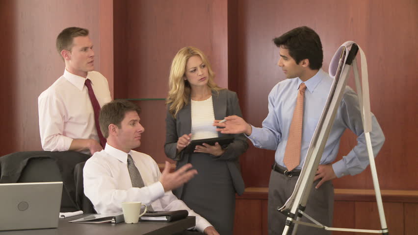 Young business man making presentation to coworkers