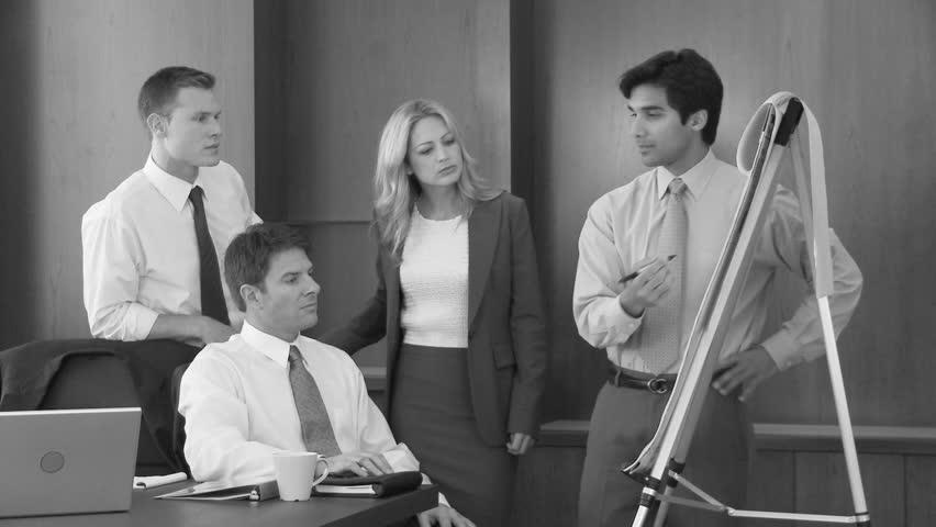 Young business man making presentation to coworkers