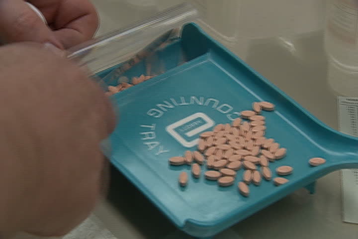 A pharmacist sorting pills.