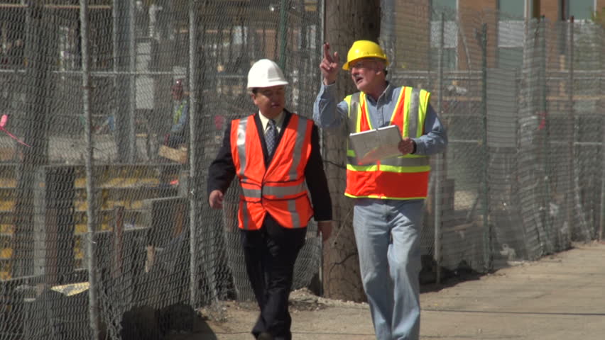 Construction worker and business man visiting construction site