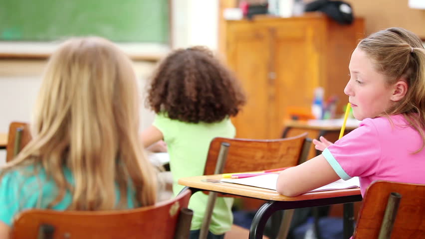 Pupils listening to their teacher in the classroom
