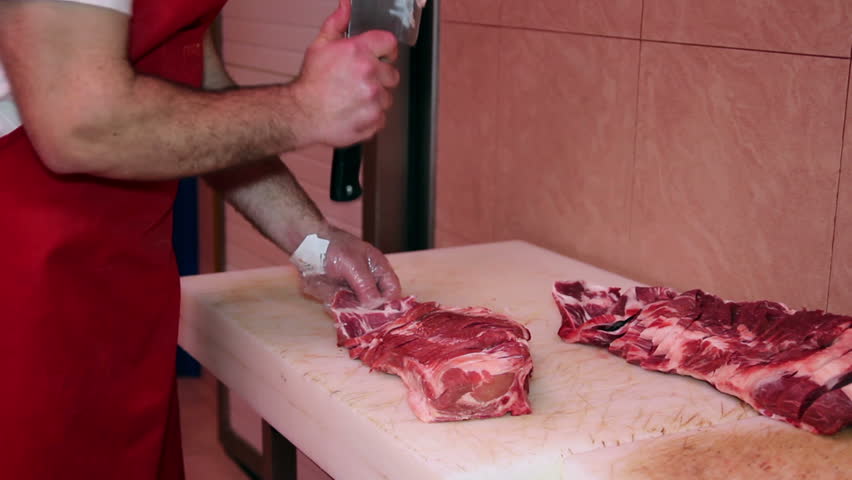 Butcher man hand cutting raw meat with meat chopper. HD1080p. 
