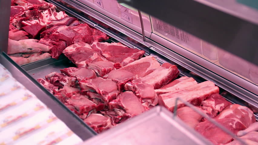 Butcher arranging meat in display case. HD1080p. 