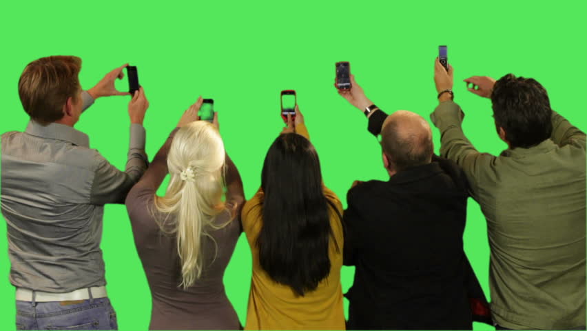 Crowd taking pictures on green screen
