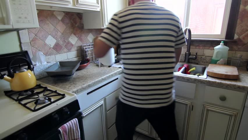 Man Cleans Kitchen
