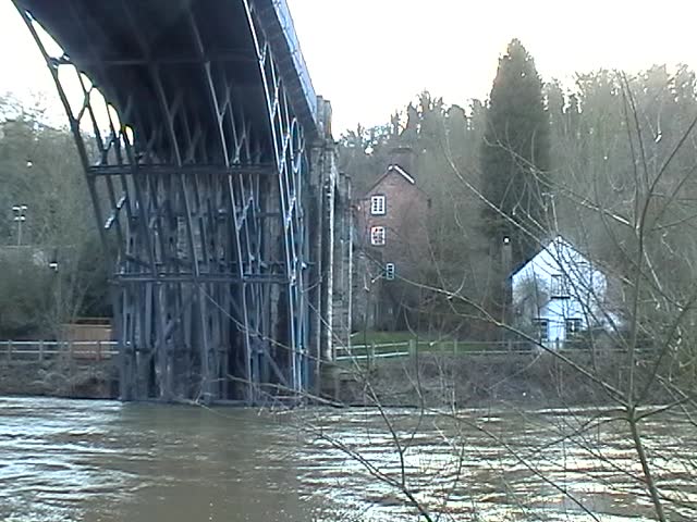 The Iron Bridge crosses the River Severn at the Ironbridge Gorge, by the village of Ironbridge, in Shropshire, England. It was the first bridge in the world to be made out of cast iron