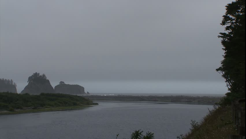 Quillayute river pan out to surf and beginning of Rialto Beach in Olympic National Park