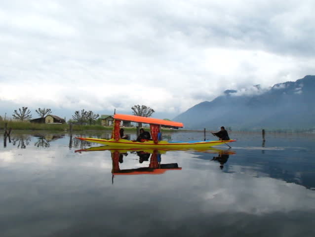 Tourist take a Shikara boat riding for sightseeing around Dal lake in Srinagar , Jammu & Kashmir India