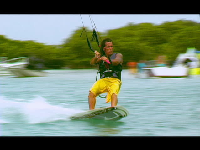 Shot in tropical waters, this kitesurfer wipes out. Shot from medium wide then into an extreme close up and rider point of view of kiter.