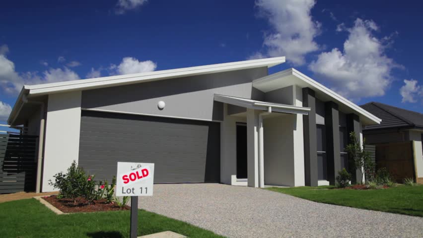 Stylish new suburban Australian home with SOLD sign. Dolly shot.
