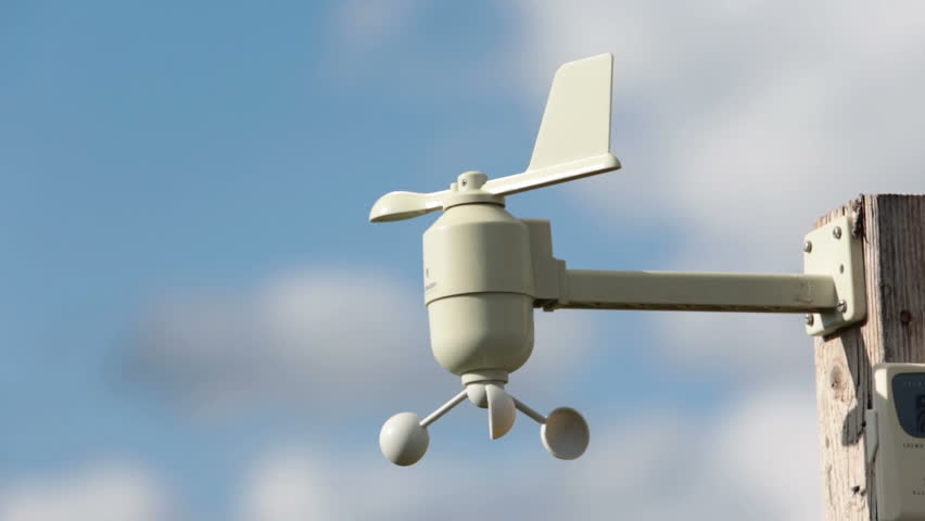 Weather vane wind gauge for direct and strength. Blue sky with white clouds in background.. Forecast of storms and disaster. HD 1080 video.