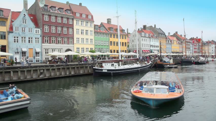 Excursion motorboats at Nyhavn canal on July 12, 2011 in Copenhagen, Denmark. Nyhavn is one of the most beautiful quarters with many trendy cafes and bars