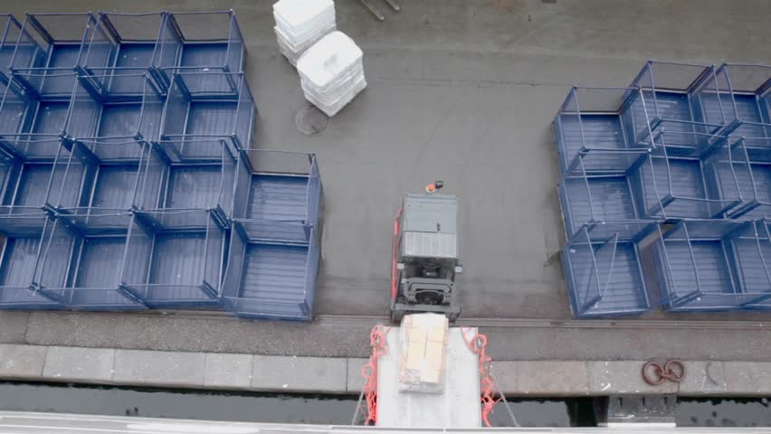 Loader moves backward from cargo and second ride away, view from above