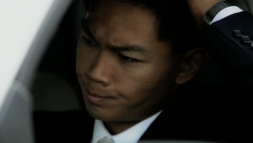 business man sitting in car with frustrated look on his face