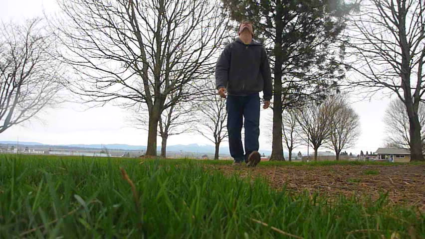 Man walks up to camera and lifts off from ground like Superman.
