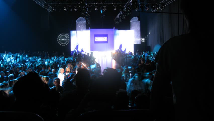 MOSCOW - APR 8: (Timelapse View) Many visitors crowd near podium in dark on VOLVO - Week of fashion in Moscow in Gostini dvor, on April 8, 2012 in Moscow, Russia