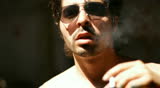 handsome man looking sexy - posing with sunglasses and smoking