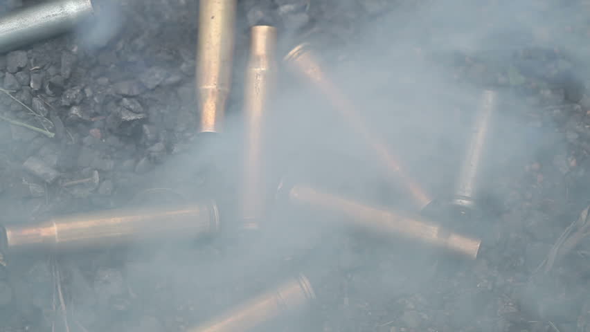 spent ammunition cartridges falling from a rifle