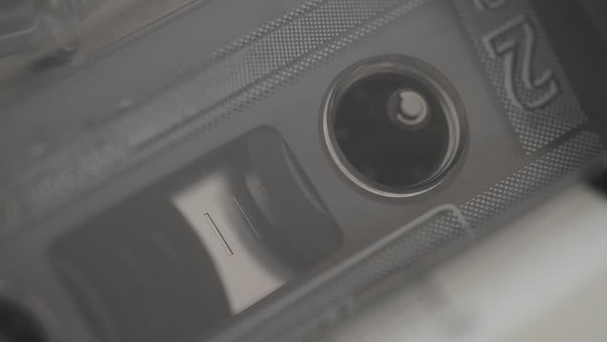 Audio cassette in cassette deck close up