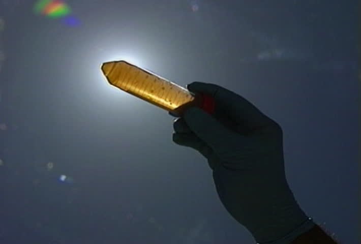 Holding up a vial to the light